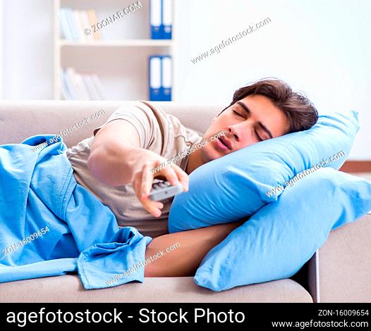 The man watching tv from bed holding remote control unit