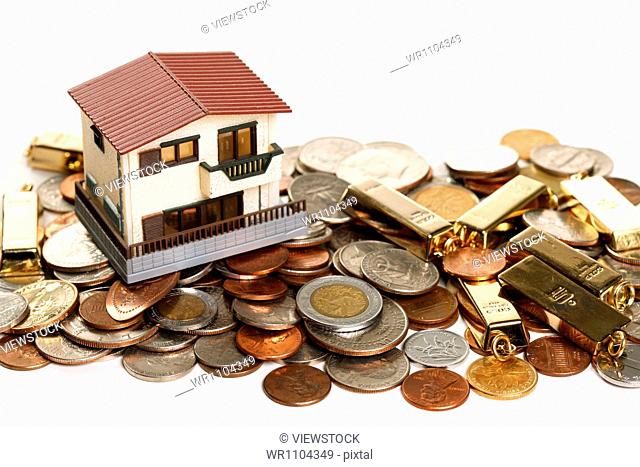 Architectural model, coins and gold bars