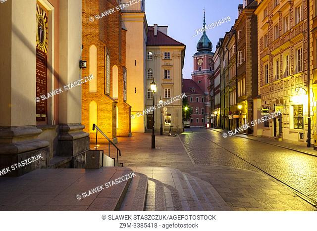 Dawn in Warsaw old town, Poland. Royal Castle in the distance