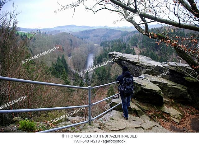 A hiker stands on a ledge in the Wolkensteiner Schweiz in the Ore Mountains in Wolkenstein,  Germany, 28 November 2014. Photo: Thomas Eisenhuth/dpa - NO WIRE...