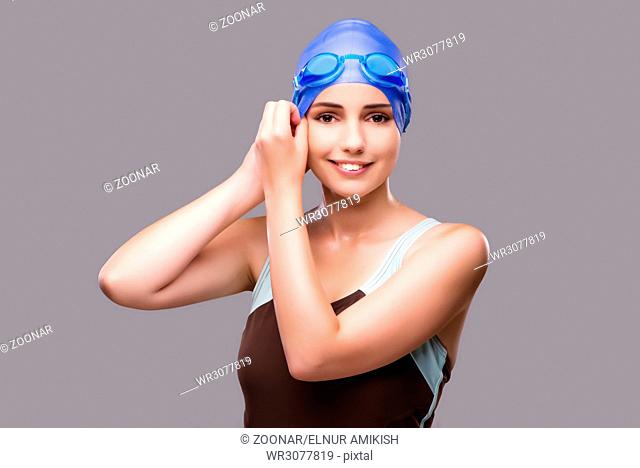 Woman swimmer against grey background