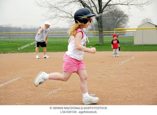 5 year old running wearing a protective helmet and tennis shoes
