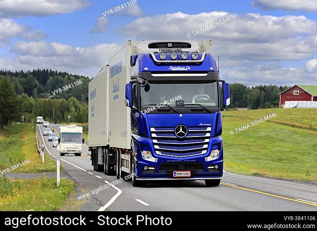 Blue Mercedes-Benz Actros truck of Siirtolinja Oy pulls refrigerated trailer in highway traffic in late summer. Ikaalinen, Finland. August 12, 2018