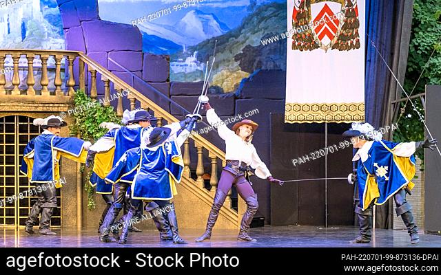 24 June 2022, Brandenburg, Cottbus: Dancers of the Staatstheater Cottbus, Emily Downs (2nd from right)as D'Artagnan, dance during the dress rehearsal for the...