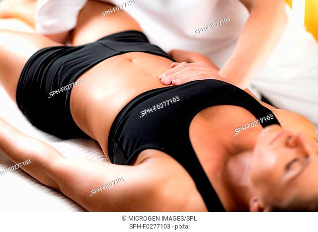 Chiropractor working with female athlete