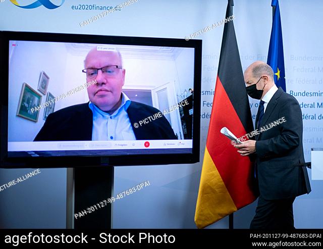 27 November 2020, Berlin: Olaf Scholz (SPD), Federal Minister of Finance, leaves the press conference in the Ministry of Finance with a mouth-and-nose cover...