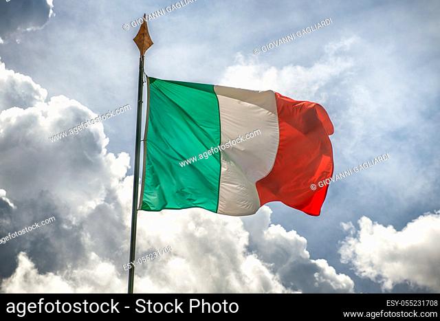 Italian flag waving against the blue sky