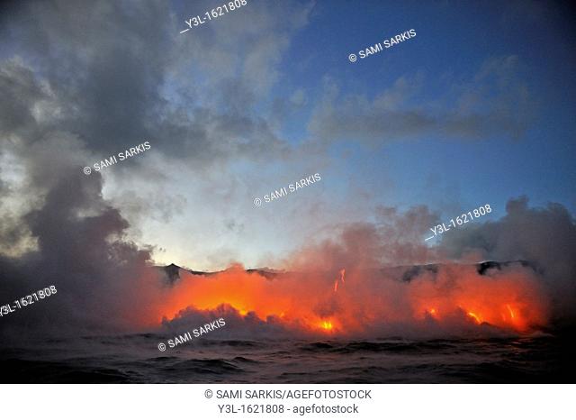 Steam rising off lava flowing into ocean at dusk, Kilauea Volcano, Big Island, Hawaii Islands, USA