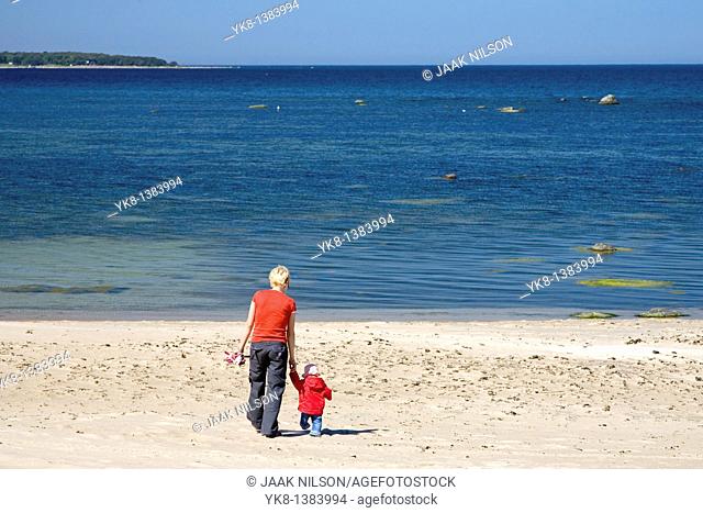 Mother and Daughter Walking Away Hand in Hand on Vääna-Jõesuu Beach by Baltic Sea, Estonia, Europe