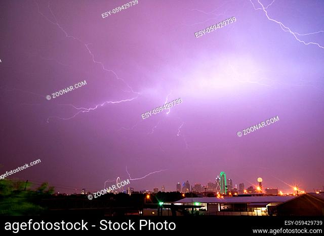 The sky is lit up purple over Dallas during a summer thunderstorm