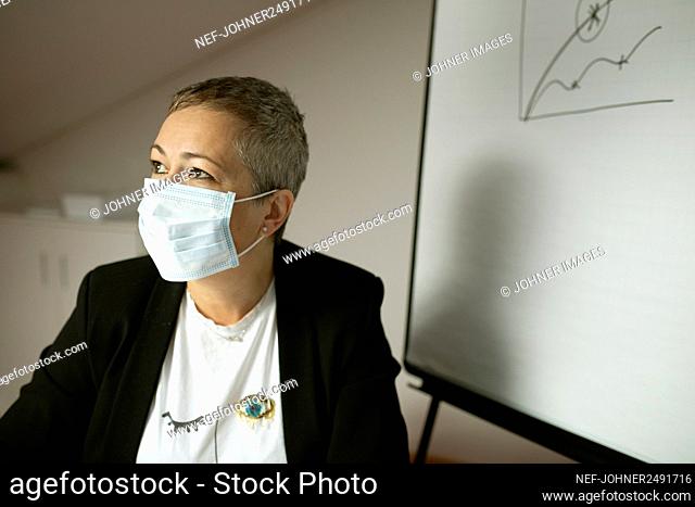 Woman wearing face mask looking away
