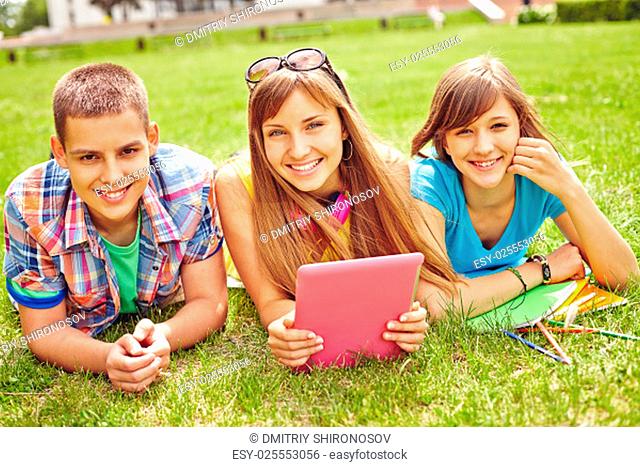 Cheerful teenagers looking at camera during summer rest