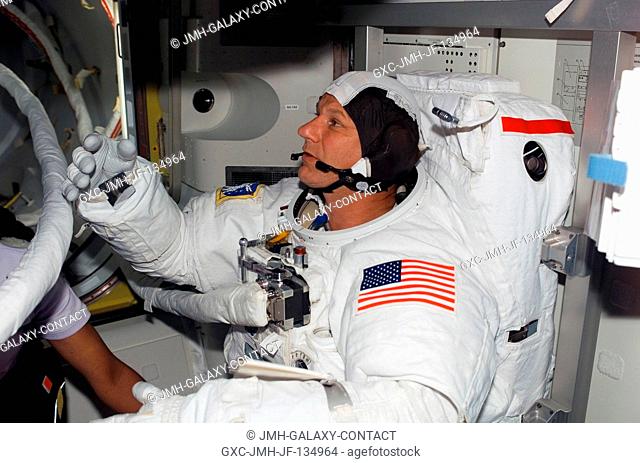 Astronaut Piers J. Sellers, STS-121 mission specialist, attired in his Extravehicular Mobility Unit (EMU) spacesuit, prepares for the start of the mission's...