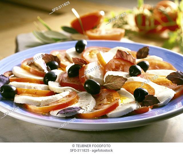Caprese con le olive Tomatoes and mozzarella with olives
