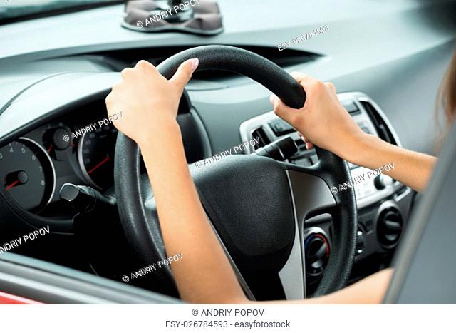 Close-up Of Female's Hand Holding Steering Wheel