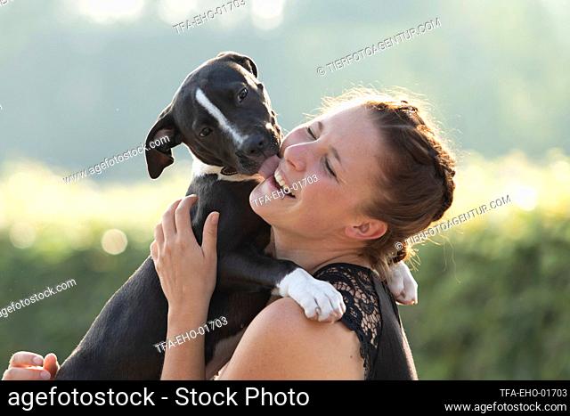 woman and young mongrel