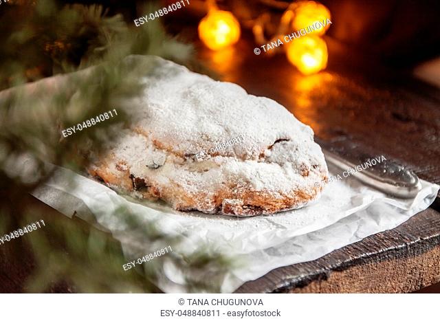 Dresden Stollen is a Traditional German Cake with raisins on a light knitted background.Gift for Christmas.Vintage style.Fruit cake for the Holiday