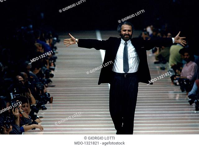 Gianni Versace on the runway. The Italian stylist Gianni Versace walking on the runway at the end of his fashion show. 1986
