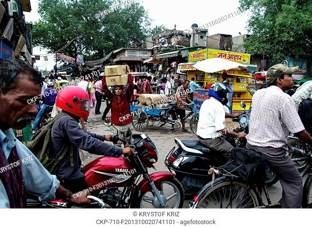 Traffic in Chadni Chowk in Old Delhi, India on July 30, 2012. Rickshaw, motorbike, a man carries boxes on his head. (CTK Photo/Krystof Kriz)