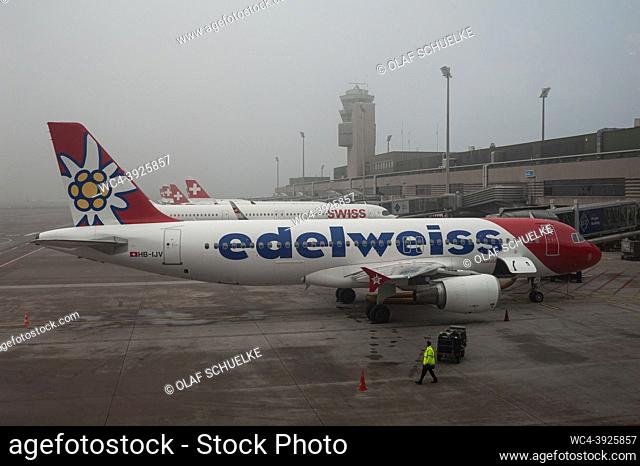 Zurich, Switzerland, Europe - An Edelweiss Air Airbus A320 passenger aircraft with the registration HB-IJV is parked at a gate of Terminal A at Zurich Airport...