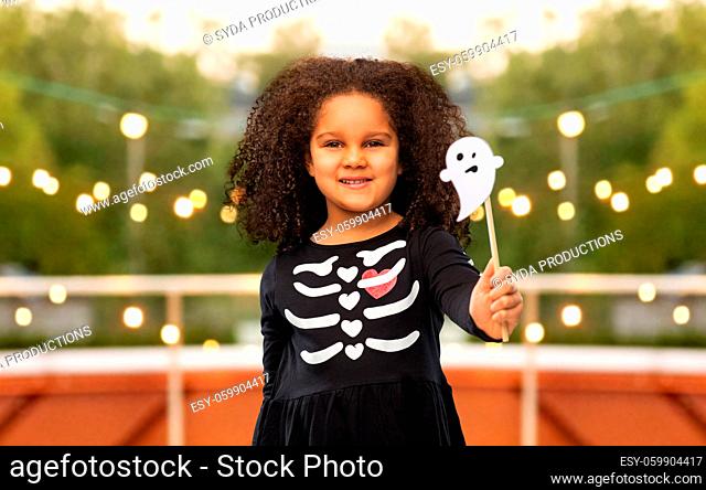 girl in black halloween dress with skeleton bones
