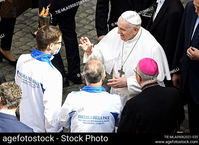 Pope Francis blesses the torch of peace of the Macerata Loreto pilgrimage carried by the torchbearer during the General audience of Wednesday   Journalistic use...