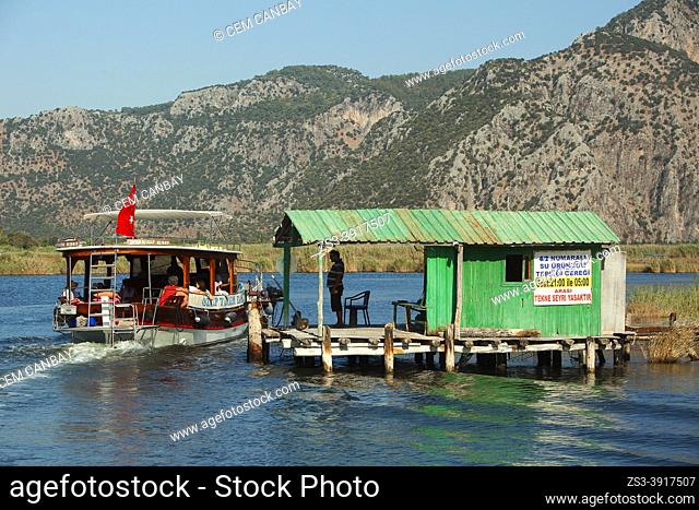 Touristic river boat passing a fishnet sluice for regulating the fish stock on Dalyan River, Mugla Province, Aegean Region, Turkey, Europe