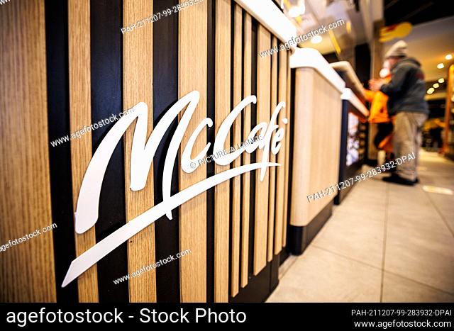 02 December 2021, Bavaria, Munich: The lettering McCafé can be seen in a branch of the fast food chain McDonald's in Martin-Luther-Strasse