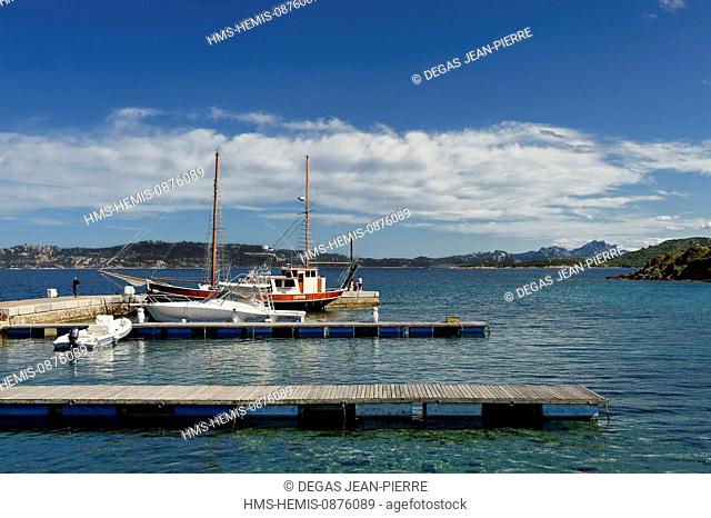 Italy, Sardinia, Olbia Tempio Province, Le Saline, marina, caiques (traditional sailboats) moored alongside with Mount Cugnana in the background