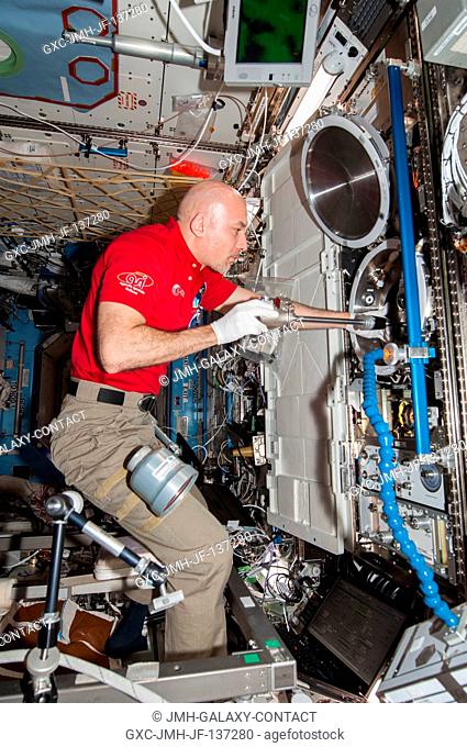European Space Agency astronaut Luca Parmitano, Expedition 37 flight engineer, works with the Combustion Integrated Rack (CIR) Multi-user Drop Combustion...