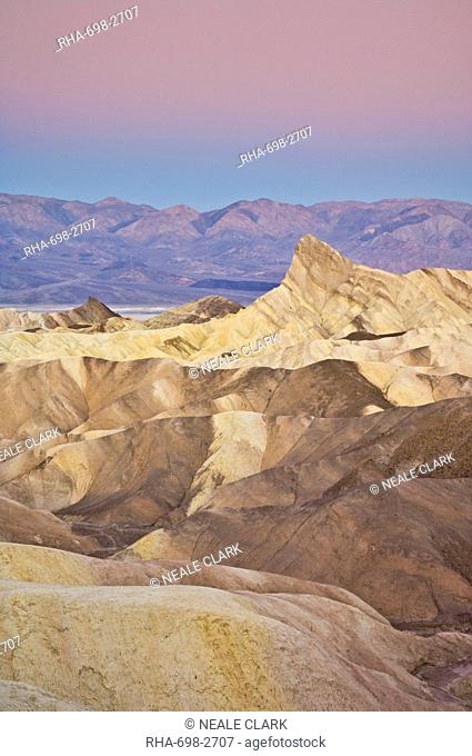 Manly Beacon and the Siltstone eroded foothills formations at Zabriske Poin at sunrise, Furnace creek, Death Valley National Park, California