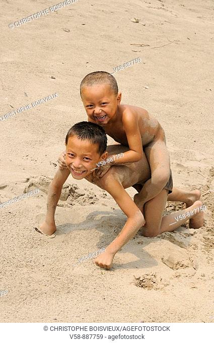 Children at play on a sandy beach by the Mekong, Pakbeng, Oudomxay province, Laos