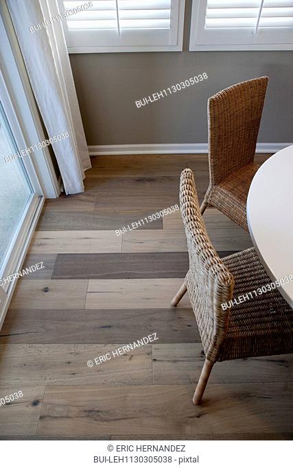 High angle view wicker chairs at dining table