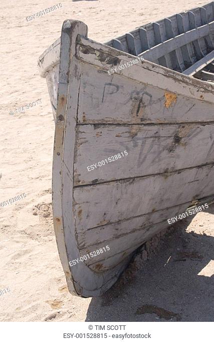 Abandoned fishing boat on sand