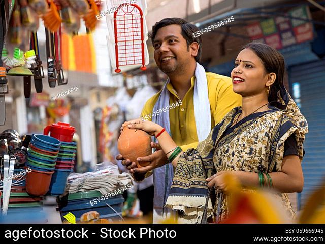 A RURAL COUPLE HAPPILY SHOPPING FOR HOUSEHOLD ITEMS