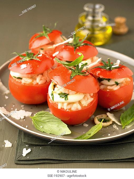 Raw tomatoes stuffed with squid risotto