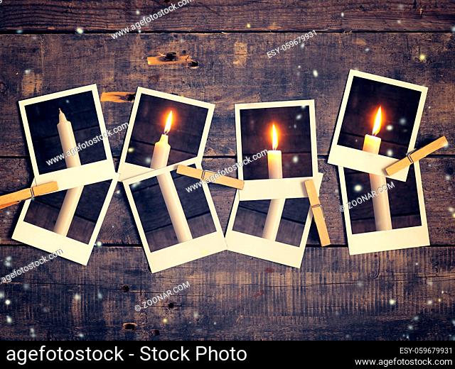Old instant photograph with four candles on a rustic wooden background, Advent concept background retro film stylized