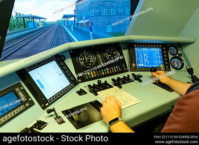 14 November 2022, Hamburg: A locomotive driver sits in the driver's seat of the rail simulator. All train drivers have to have their driving skills tested in...