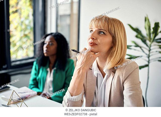Businesswomen attending a workshop in conference room