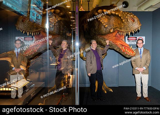11 March 2021, Lower Saxony, Hanover: Annette Richter and Daniel Hercenberger, exhibition curators, stand next to a Tyrannosaurus Rex in the exhibition...