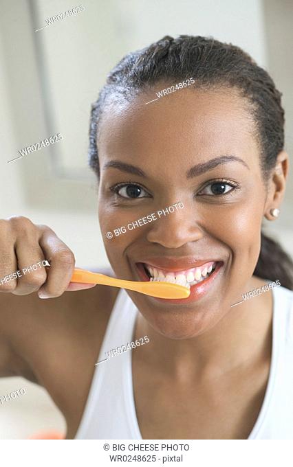 A young woman brushing her teeth