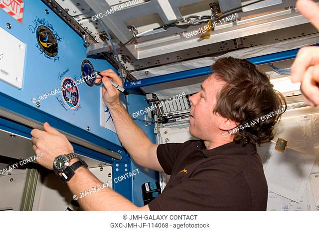 Flight day 11 activities for the joint shuttle-station crews included the traditional autographing of the station. Astronaut Mike Barratt