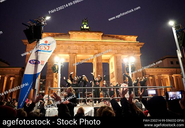 14 February 2023, Berlin: Dancers dance on a stage in front of the Brandenburg Gate. Today for Valentine's Day, a dance demonstration against violence against...