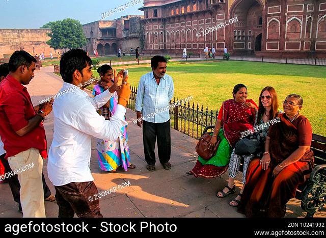 Tourists taking photos outside Jahangiri Mahal in Agra Fort, Uttar Pradesh, India. The fort was built primarily as a military structure