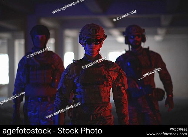 soldier squad team walking in urban environment colored neon lights