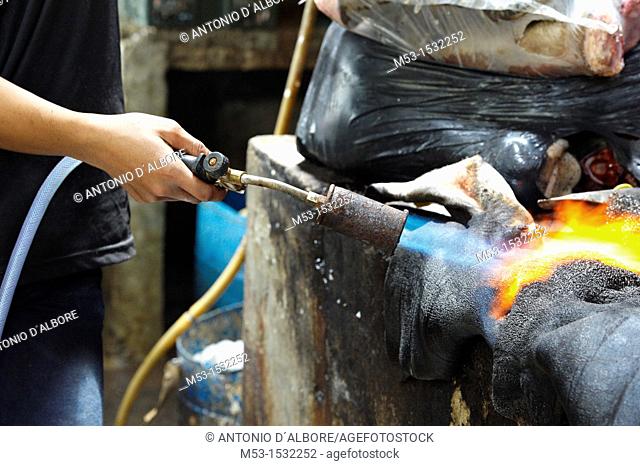 Burning cow skin with a gas burner  The skin is later cleaned from burned pieces and sold as ingredient for soup and other Malay recipes  Kuala Lumpur  Malaysia