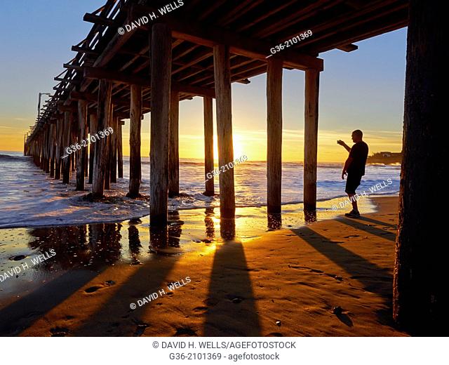 Silhouette of man at beach during sunset in Cayucas, California, United States