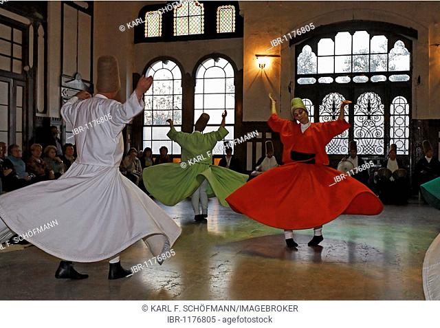 Dancing dervishes of the Sufi order Mevlevi, Sema ceremony, historic train station Sirkeci, Istanbul, Turkey