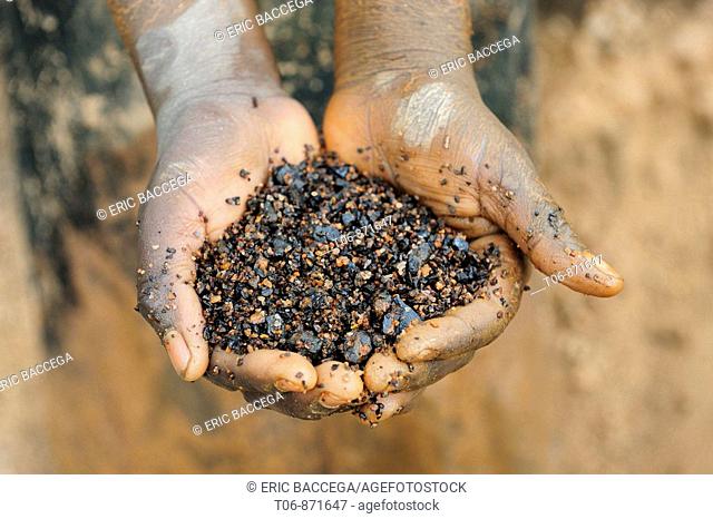 Miner with hands full of coltan metallic ore, Muhanga coltan mines, Rwanda, Africa