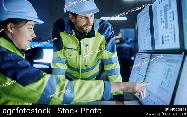 Engineers in factory control room